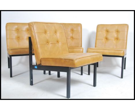 A set of four retro 20th century salon reception chairs having a metal tubular frame with a mustard vinyl button back upholst
