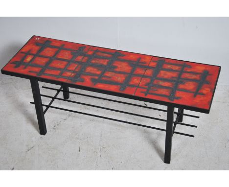 A retro 1960's Fat Lava ceramic and metal coffee table of rectangular form with tubular metal frame with red glaze West Germa