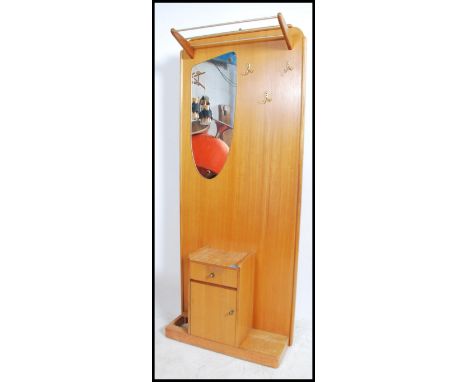 A retro 1960's teak wood hallstand having central mirror under shelf with a locker cupboard to the base center. 185cms high x