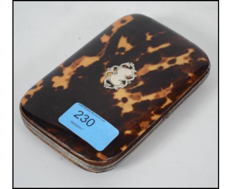 A 19th century  continental tortoiseshell and gilt metal purse having inlaid silver decoration with  internal silk lined comp
