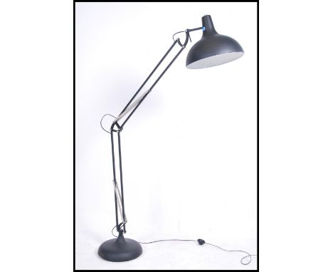 A large floor standing lamp in the form of a Herbert Terry anglepoise lamp having a terraced base with large UFO pendant shad