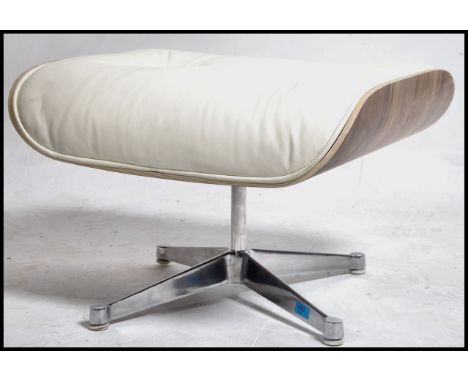 After Charles & Ray Eames. A Herman Miller  671 Ottoman raised on polished quadruped swivel base having bent-ply underside an
