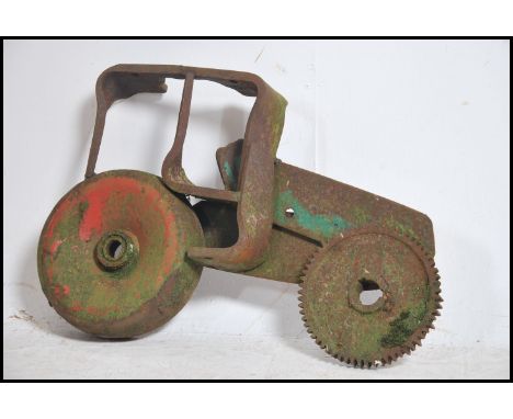 An unusual upcycled salvage folk art sculpture of a agricultural tractor being salvaged from engineering parts