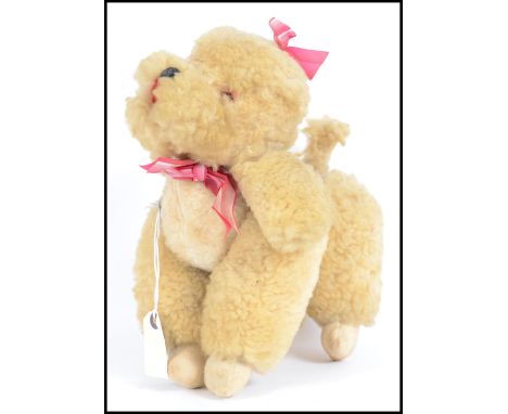A vintage early 20th century automaton.  This moving poodle dog toy doll is made from sheep's wool and has a wind up key to t