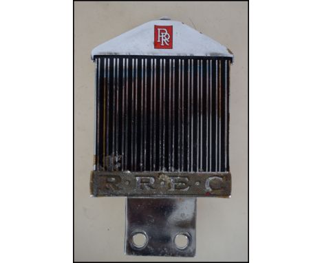 A Rolls Royce Chrome and enamel car badge with monogram for RREC to centre. Marked to the back for Marples & Beasley Birmigha