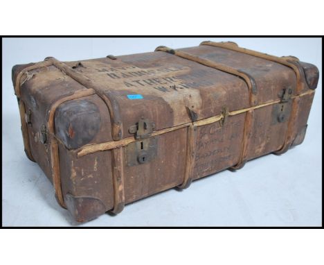 An early 20th century d-mob canvas and wooden bound steamer trunk chest with notation to centre having clasps to the front - 