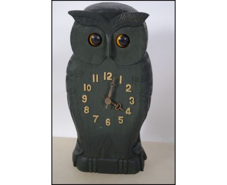 A Black Forest style clock in the form of an owl with articulating eyes. Measures 24cms.