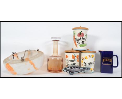 A collection of vintage and retro items to include kitchen storage jars by Toni Raymond, a 1930's mottled light shade etc.