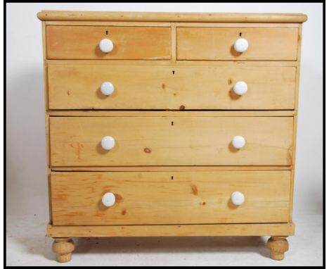 A Victorian pine 2 over 3 country chest of drawers being raised on turned legs with 2 short drawers over 3 deep drawers havin