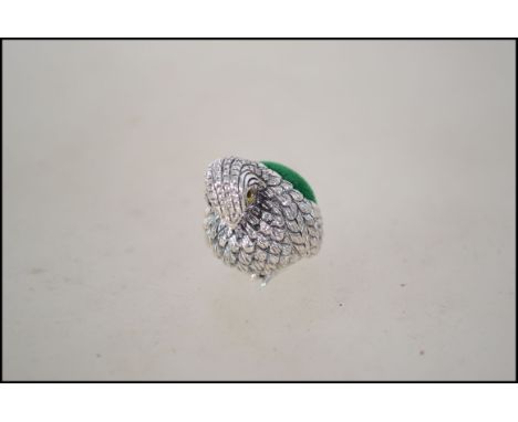 A silver pin cushion in the form of a bird. Marked sterling. Measures 2cm high