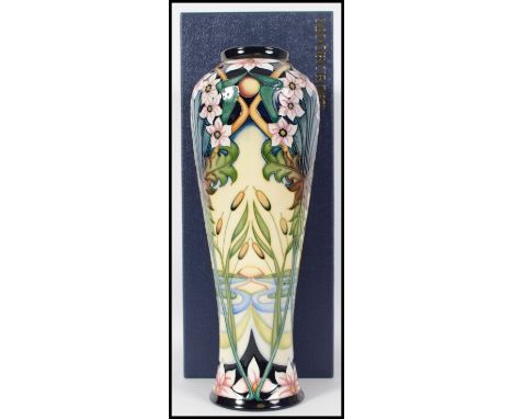 A large Moorcroft baluster vase in the Avon Water pattern featuring stylized leaf and floral sprays with bulrushes before a s