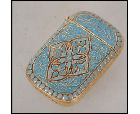 A brass vesta case with turquoise enamel decoration. Measures 5cm high. 