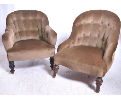 A pair of Victorian style nursing chairs raised on turned legs being upholstered in a beige velour upholstery being button ba