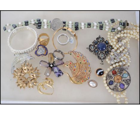 A quantity of costume jewellery to include brooches, a Timex watch and pearl necklaces together with four Jubilee coins and a