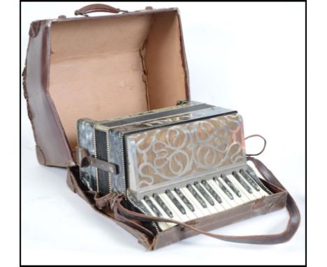 A vintage Italian Casali Verona piano accordion being twin octave with mother of pearl inlay being complete in original case.