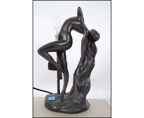 A 20th century Art Deco bronzed style lamp of a nude female figure at full stretch with head tilted back and her flowing hair