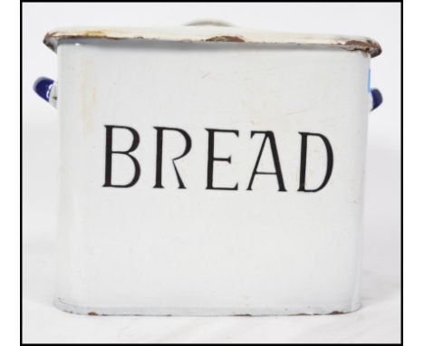 A vintage early 20th Century enamelled bread bin.  This authentic lidded piece is in white with blue handles and has 'BREAD' 