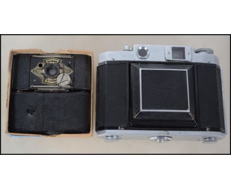 A vintage Ensign Midget camera together with another similar and a Mamiya Six slr camera in leather case