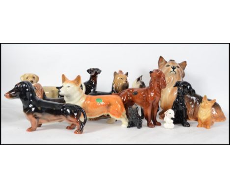 A large collection of ceramic dog figurines to include terriers, beagles, spaniels, hunter dogs etc. Makers to include Melba,