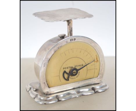 A set of Edwardian silver postage scales, by Levi and Salaman, Birmingham 1903, semi-circular form, on a shaped raised rectan