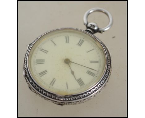A silver hallmarked ladies pocket watch, the enamel face having a Roman numeral chapter ring, With a London assay mark, maker
