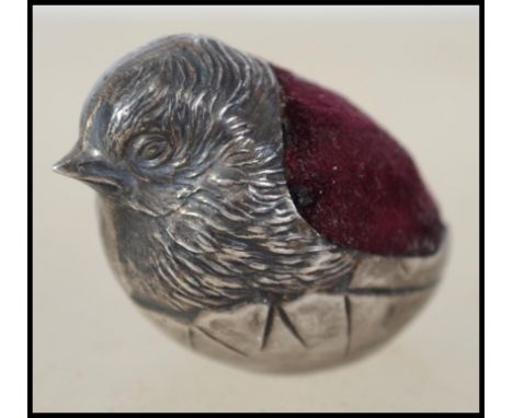A silver hallmarked miniature pin cushion in the form of a bird - wren. Red baize hallmarked to the base for Chester 1906. Ma