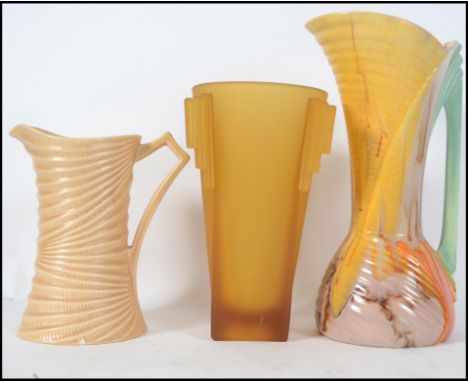 A collection of Art Deco ceramic vases in ceramic and glass to include a tall drip glaze jug, swirl jug and a frosted yellow 