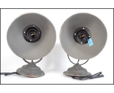 A pair of retro / vintage 20th century industrial wall lights. Each light having a circular wall mountable base with directio