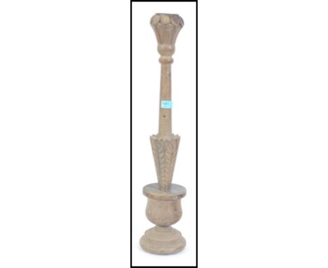 An unusual 19th century oak Ecclesiastical candle stick having soccle base with inverted stem.