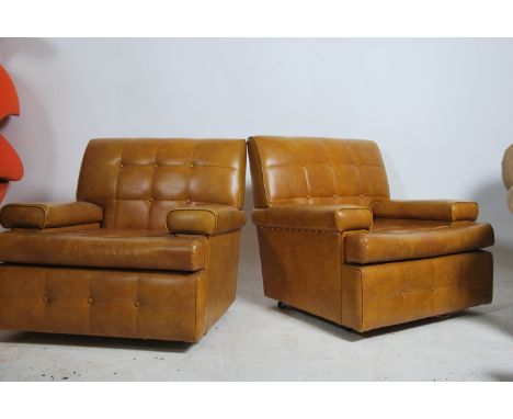 A pair of stunning retro 1960's Danish armchairs. Having a vinyl button back upholstery in stunning condition with no rips or