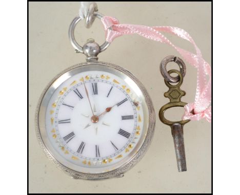 A continental silver and enamel open faced ladies pocket fob watch. The decorative face with key wind movement set all within