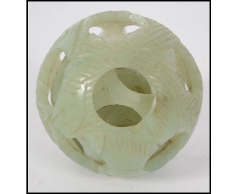 A 20th century Chinese Oriental jade three layer  carved puzzle ball. Measuring six cm diameter.