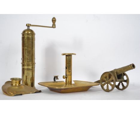 A collection of Victorian and later brass wares to include a night chamberstick, brass desk top cannon, grinder and inkwell