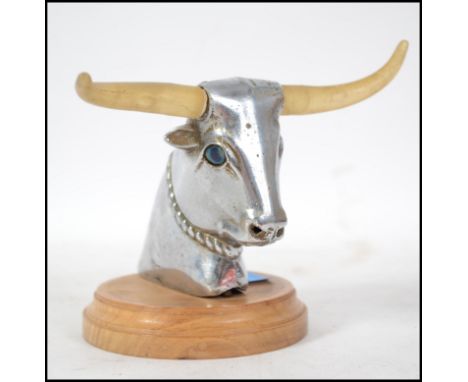 A 20th century chrome car mascot in the form of a Bulls head with light up horns.