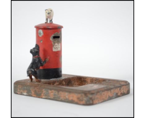 A very unusual cold painted tin plate ashtray from the early 20th Century.  This vintage piece features a red pillar post box
