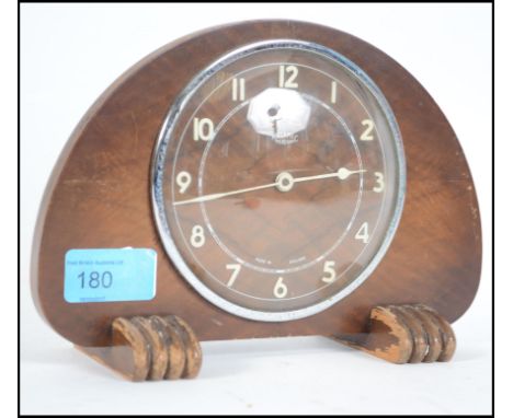 A vintage 20th century Art Deco style Metemec Dereham wooden cased mantle clock raised on wooden claw feet.