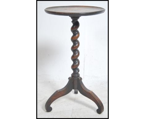 A small 19th century tripod wine table being raised on splayed legs with barleytwist column and circular top above. Measures: