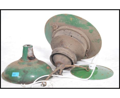 A group of three vintage 20th century industrial factory lights, each with matching green enamel shades please refer to image