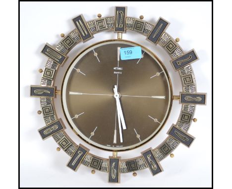 An original 1970's vintage Metamec wall clock with bronzed face and white hands.  It is styled with Aztec/Inca style decorati