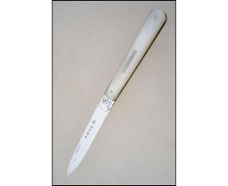 A hallmarked mid Victorian silver fruit knife with mother of pearl handle. Hallmarked for Birmingham 1865 by James Fenton.