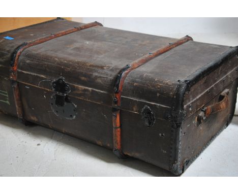 A vintage cased Steamer trunk being canvas and wooden bound with hinged centre and clasps to the front