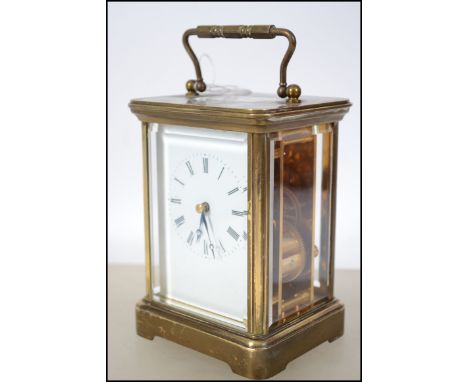 A Matthew Norman 1750 brass carriage clock having handle atop over open window escapement. Twin barrel movement striking on a