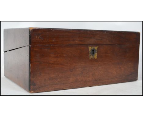 A Victorian mahogany writing slope having hinged top with brass escutheons, the interior being fully appointed with inkwell r