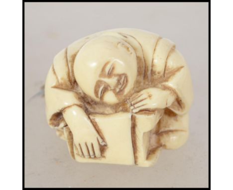 A carved Japanese bone netsuke signed to the base