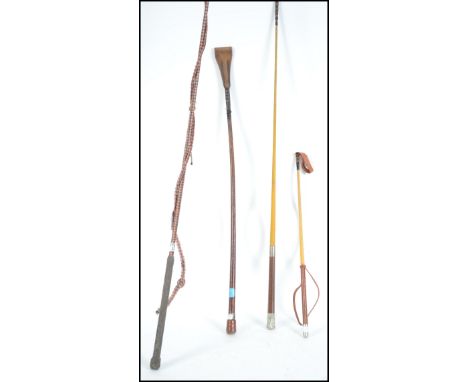 A group of vintage horse riding crops to include a silver topped example and a long training whip.