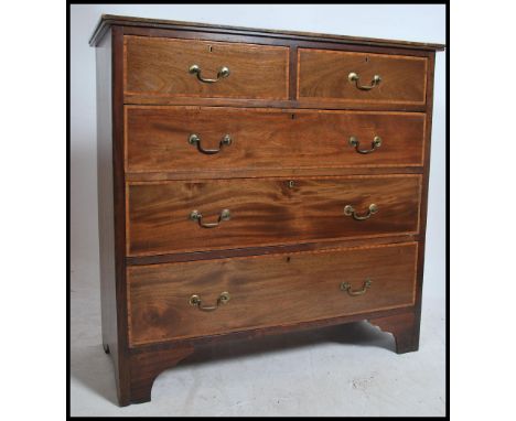 An Edwardian mahogany inlaid chest of drawers. Raised on bracket legs with 2 short drawers over deep drawers beneath. Brass s