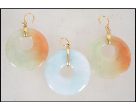 A demi Parure jade and 24ct gold earring and necklace pendant set. The white mutton fat jade roundel pendant having matching 