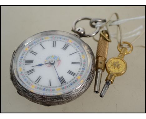 A silver 935 continental hallmarked ladies pocket watch. With an enamel face having a roman numeral chapter ring and rococo c