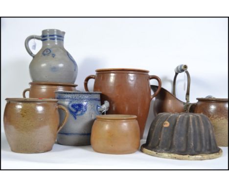 An interesting group of eight German ceramic pots/jugs/vases of various sizes three of which are double handled, some blue gr
