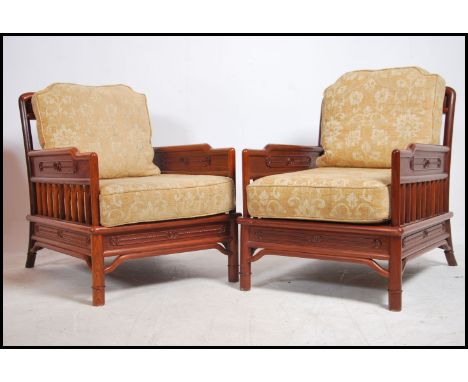 A pair of 20th century Chinese influenced hardwood upholstered armchairs. Each having gallery railed open frames with over st